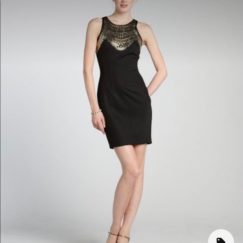 Black body conscious dress with gold-tone details. Used.